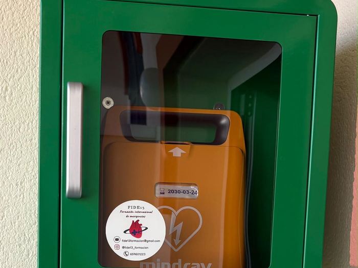 Vitrina verde con desfibrilador Mindray y la fecha de caducidad de los electrodos a la vista